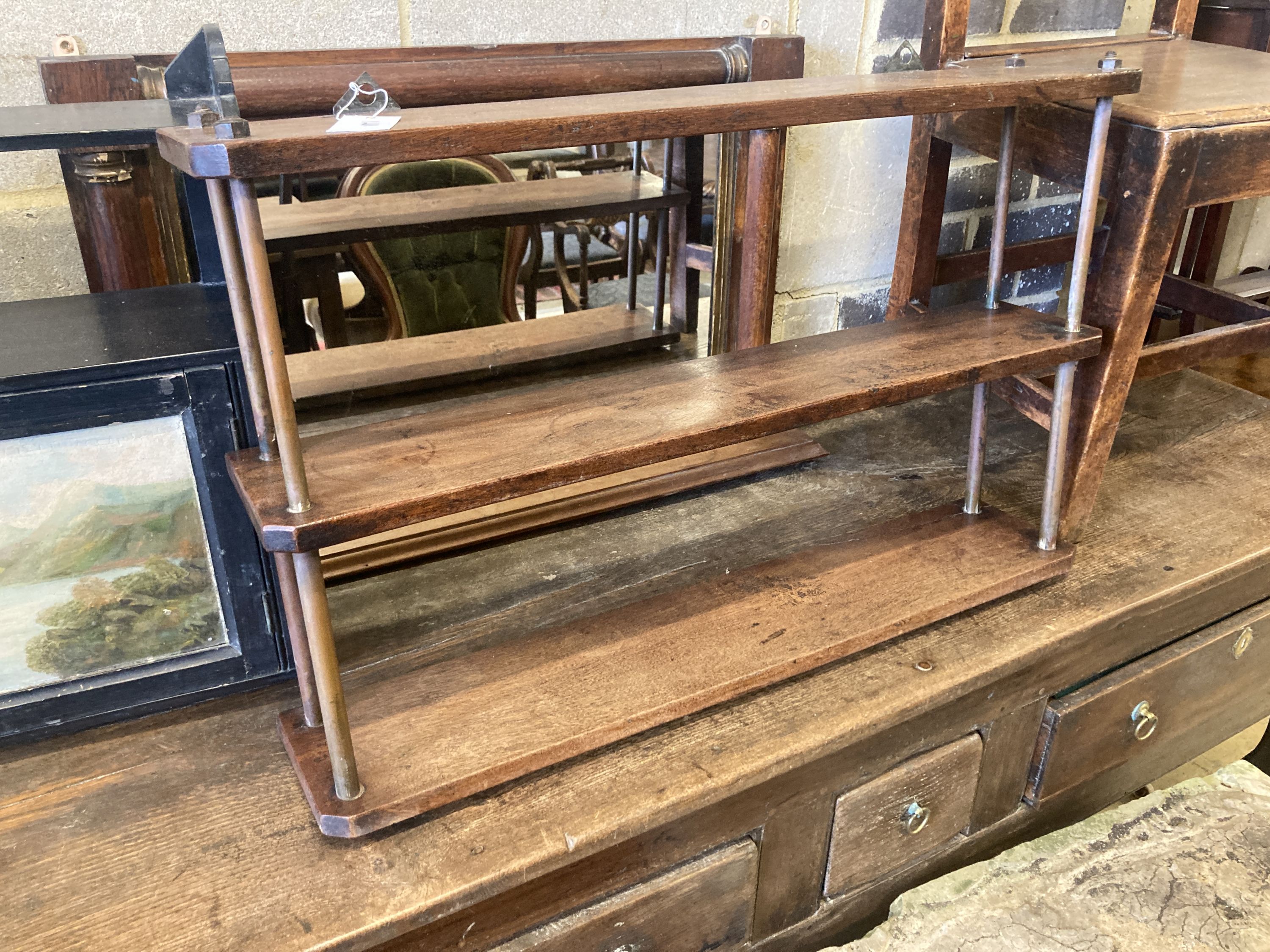 A late Victorian wall cabinet painted with a landscape scene, width 47cm, pair of provincial wood seat chairs, a mahogany three tier wall shelf and a Victorian overmantel mirror